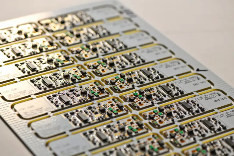 Close-up of a circuit board with rows of small components, including resistors and capacitors. It conveys a sense of precision and technology.