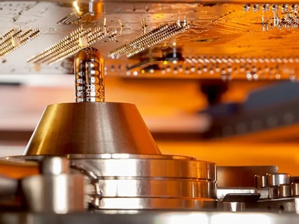 Close-up of a circuit board being selectively soldered. The scene conveys a high-tech, precise atmosphere.